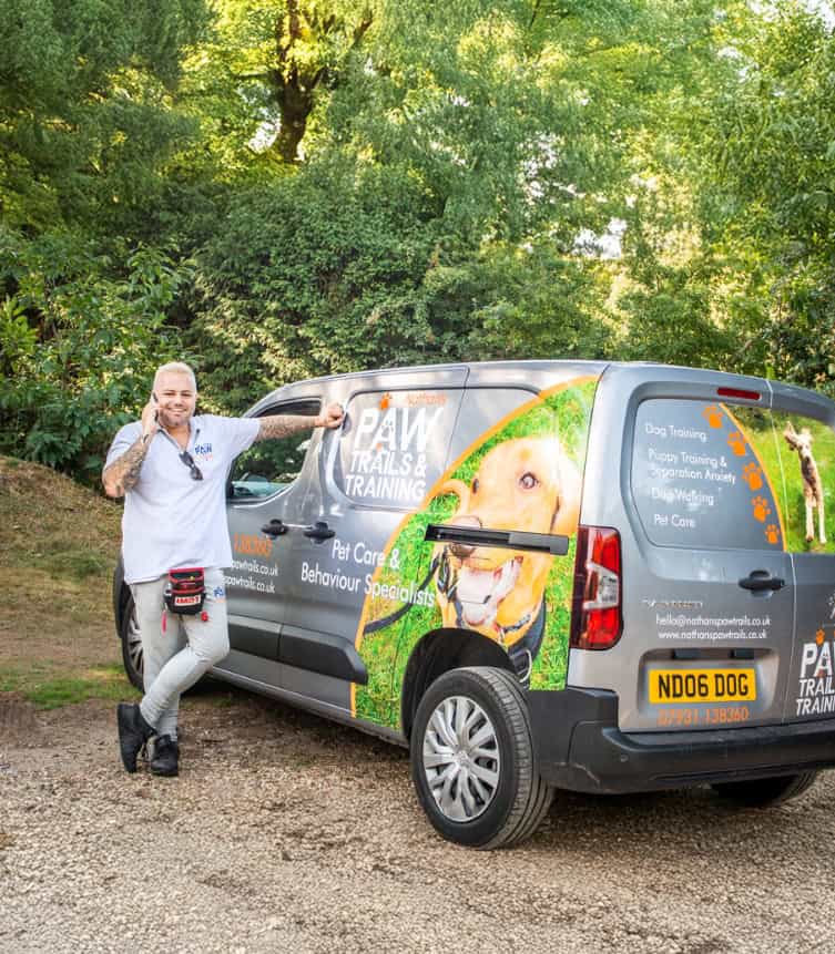 Nathan from Nathan's Paw Trails on the phone to a client